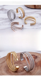 Detail of 18K gold plated multi-layer stainless steel C-shaped cuff wire bracelets