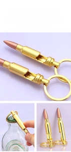 Zinc alloy bullet bottle opener keychain with gold and copper finish in use