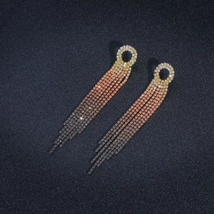 Detail of long tassel earrings with champagne to rose and grey gradient rhinestones