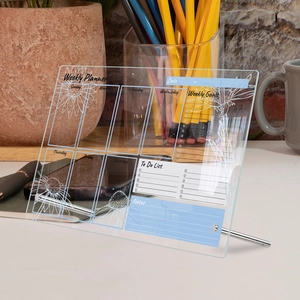 Acrylic weekly planner on metal stand with floral patterns for desk organization