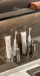 Dual wall-mounted grey toothbrush holders with inverted cups and adhesive mount system