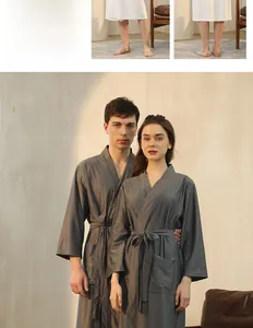 Detailed view of grey waffle weave bathrobe showing texture, belted waist and pocket