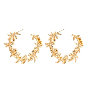Golden metal hoop earrings with wheat leaf pendant design in minimalist retro style