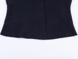 Detail of the navy wool blend hemline showing refined stitching and soft fabric texture