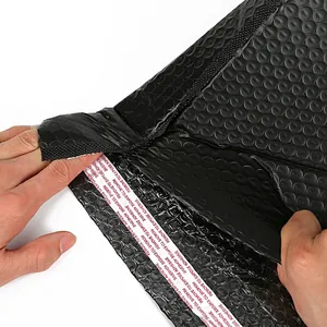 Durable black padded bubble mailer showing tear-resistant strength and strong adhesive strip