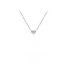 Macro detail of a heart-shaped pendant necklace featuring three brilliant-cut cubic zirconia