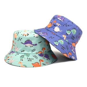Kids reversible bucket hats with cartoon dinosaur prints in mint green and blue colors