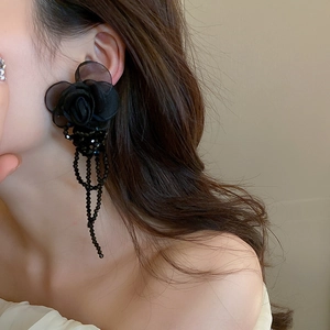 Elegant vintage black lace flower earrings with crystal tassels on a female model
