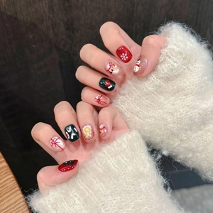 Hand-painted Christmas press-on nails with snowman and gingerbread man festive designs