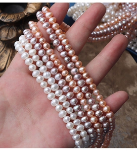 Macro detail of natural freshwater pearl strands in white pink and purple colors