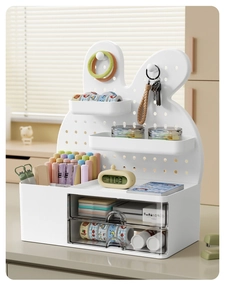 Detail of white desk organizer with transparent drawers and rabbit pegboard setup