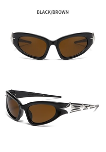Detail of Y2K cyberpunk sunglasses with silver gothic star design and black frames