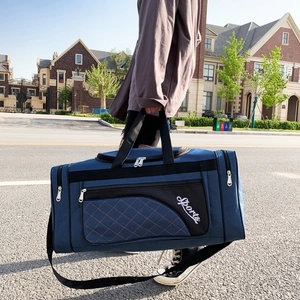 Detail of dark blue Oxford fabric travel bag with diamond quilted stitching and strap