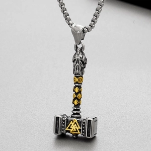 Detail of Viking Mjolnir pendant with wolf head and gold Valknut on steel chain