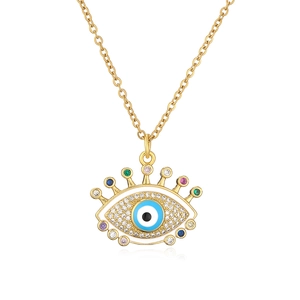 Detailed shot of gold evil eye pendant necklace with colorful gemstones and white zircons