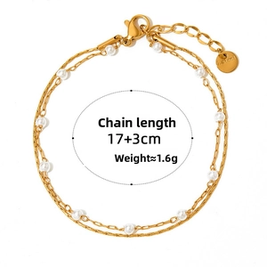 Detail of double-layer gold stainless steel bracelet with small white pearls