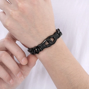 Close-up of black carved Cuban chain bracelet with vintage pattern for men