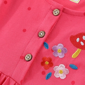 Pink knit baby dress featuring polka dots, wooden buttons, and floral mushroom embroidery