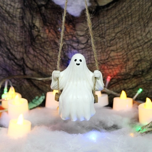 Detail of a white ghost figurine on a wooden swing with hemp rope for Halloween decor