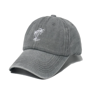 Washed dark gray baseball cap featuring white coconut tree embroidery on white background