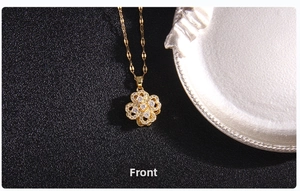 Front view of rotating lucky clover necklace pendant with white zircon in gold finish