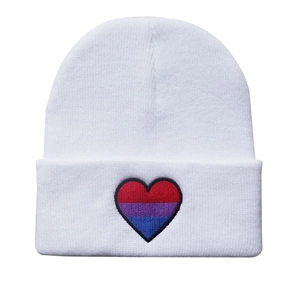 Detailed view of the bi-sexual pride heart embroidery on a white knitted beanie hat