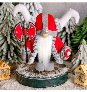 Close-up of Viking gnome with horned hat, fur beard, wooden shield and red battle axe