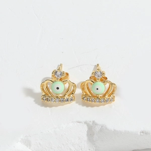 Detailed macro of golden crown stud earring featuring devil eye bead and white zircon