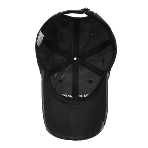 Internal view of black cotton baseball cap showing 100% cotton label and metal buckle