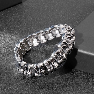 Gothic style silver stainless steel skull bracelet with cross motif on dark background