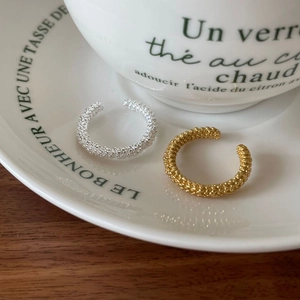 Minimalist 925 sterling silver beaded ear cuffs in gold and silver finish on a ceramic tray