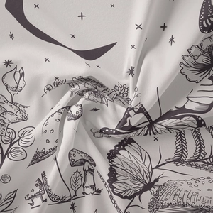 Close-up of soft fabric tapestry featuring botanical mushroom and butterfly line art