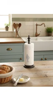 Close-up of vintage cast iron vertical paper towel holder with decorative crown finial