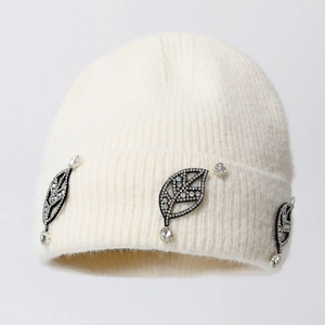 White knit beanie hat with fuzzy mohair texture and shimmering rhinestone leaf patches