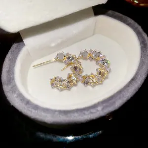Elegant C-shaped crystal stud earrings with pavé zircons in gold-plated finish