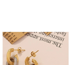 Close-up of interlocking gold and silver earrings with vertical textured stripe design