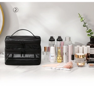 Detail of black mesh double-layer makeup bag with handle and tiered storage design