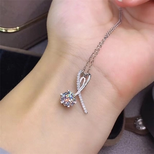 Detail of a 2ct round zircon pendant necklace with heart-shaped lines shown on wrist
