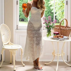 Detail of elegant white lace maxi dress featuring intricate floral embroidery and slim fit