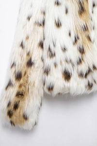 Close-up detail of leopard print faux fur coat showing soft texture and pattern