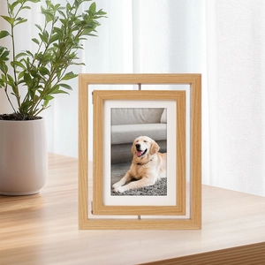 Rotating double-sided wooden photo frame with pet portrait on a modern minimalist desk