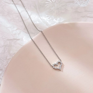 Elegant hollow heart pendant necklace with zircon crystals on a fine silver chain