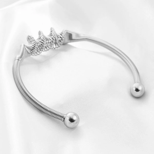 Detailed view of silver stainless steel screw cuff bracelet with spiral coil texture