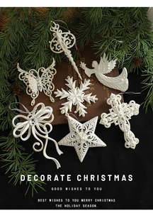 Detailed close-up of white glitter Christmas ornaments including angels and snowflakes