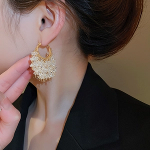 Close-up of elegant 18k gold plated hoop earrings with white crystal cluster tassels