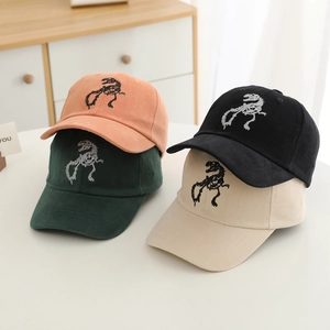 Close-up of high-quality cotton baseball caps featuring dinosaur skeleton embroidery
