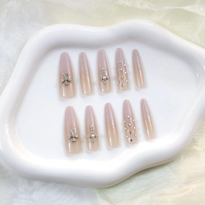 Long almond press-on nails with white gradient, silver crosses and sparkling rhinestones