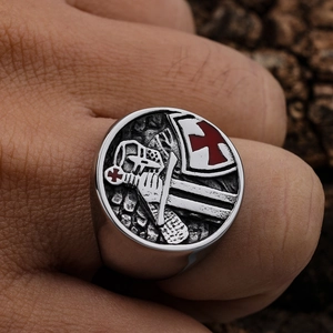 Close-up of vintage Templar cross signet ring with knight helmet and red shield detail