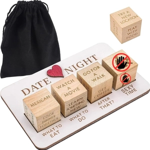 Detail of wooden date night dice set with engraved activity options and black pouch