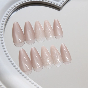 Pink cat-eye press-on nails with almond shape and silver glitter gradient finish